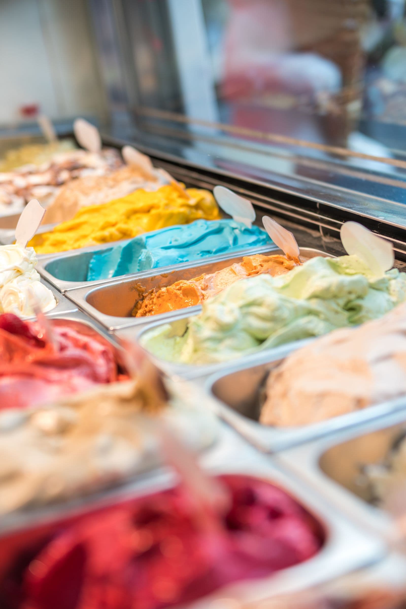 Trays of brightly coloured gelato lined up along the shop counter